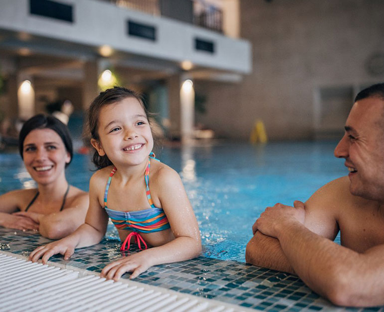JCB-Consulting-converting-leads Family in hotel pool smiling